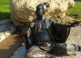 公園坐在地上的古代人物銅雕 